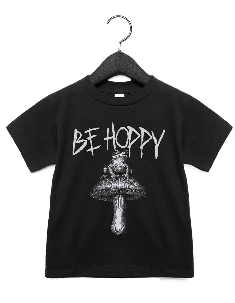 Toddler t-shirt featuring a funny illustrated animal design of a magical frog on a mushroom – playful and cool kids tee with bold nature-inspired graphic, perfect for adventurous toddlers, unique kids gift or trendy preschool outfit.