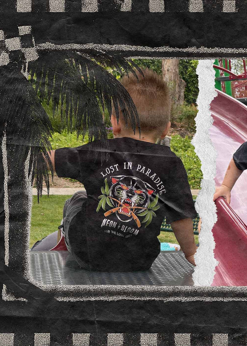 Two children wearing black t-shirts with graphic designs in a decorative frame.