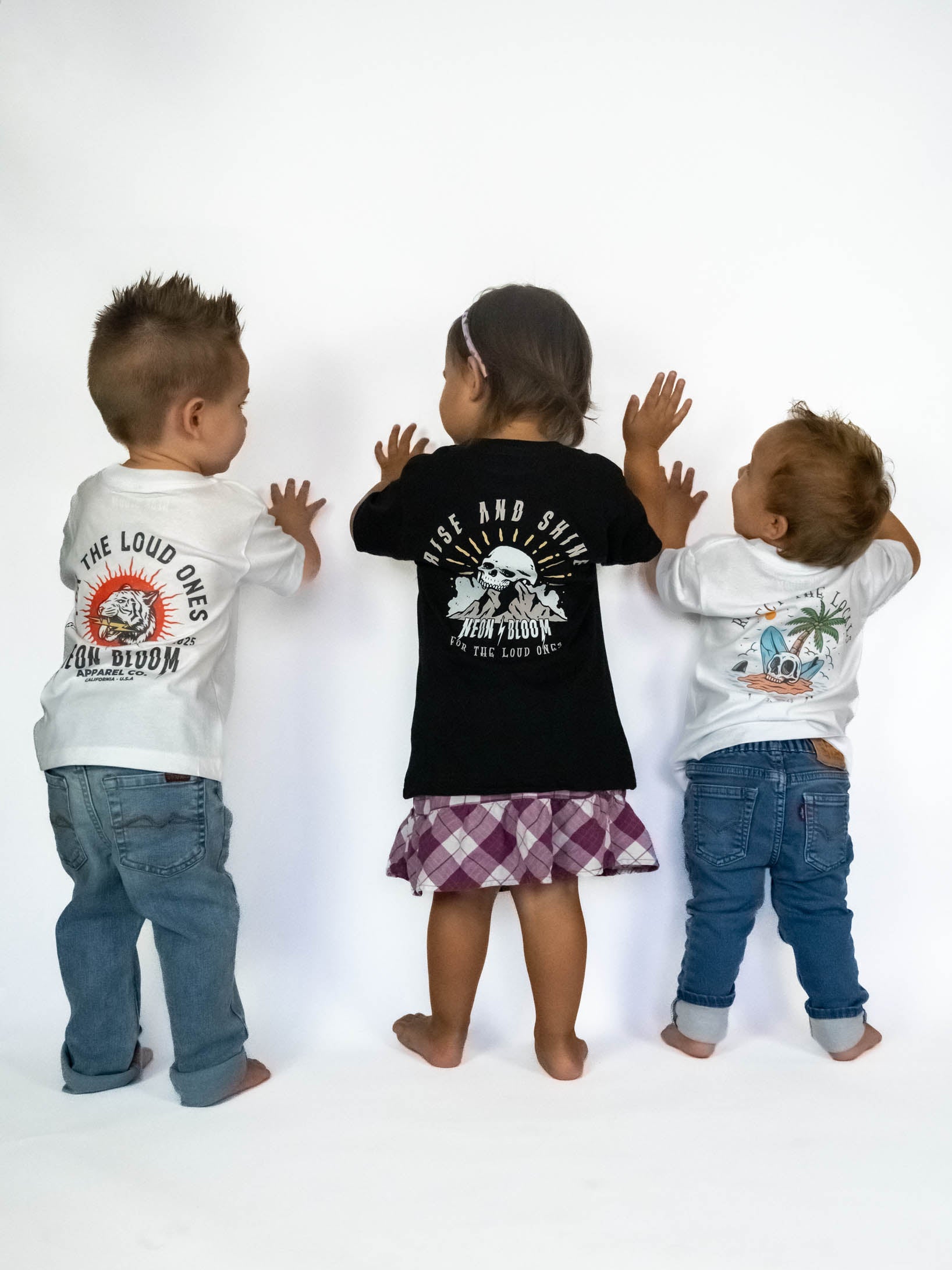 Neon Bloom toddler apparel t-shirts with different designs on a white background